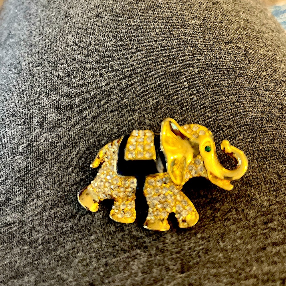 Elephant brooch, gold metal, sparkling stones, green stone eye, black saddle